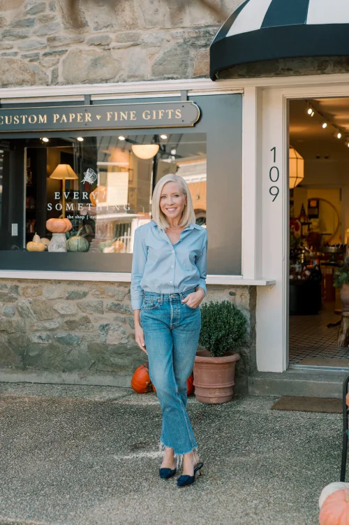 Nicole, lead designer and owner of Every Little Something, standing in front of the studio storefront.