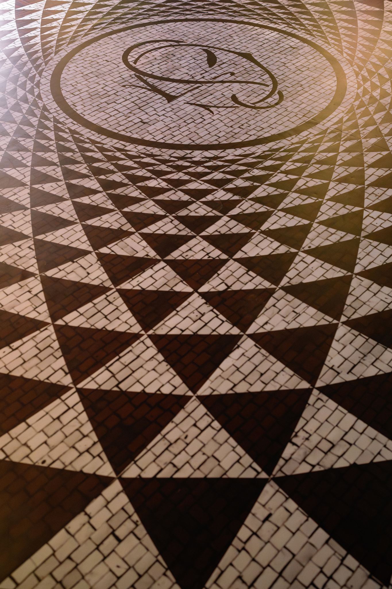 Custom wedding dance floor with a personalized monogram at the center of the reception space.